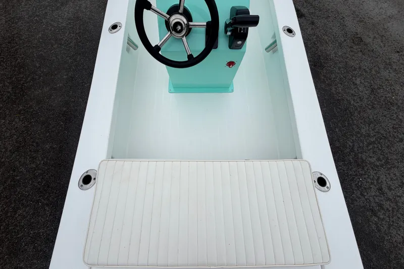 Slide: The Image of 2025 Exuma 14 Snookaholic boat interior with steering wheel and control panel. - 14