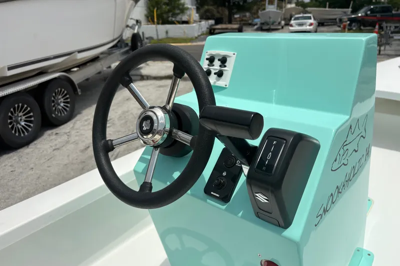 Slide: The Image of Steering console of 2025 Exuma 14 Snookaholic boat, featuring sleek design and controls. - 24