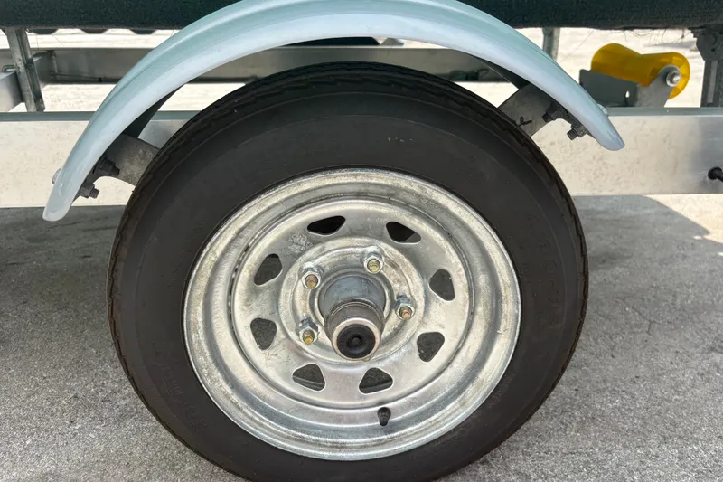 Slide: The Image of Trailer wheel of 2025 Exuma 14 Snookaholic, featuring a metal rim and tire. - 29