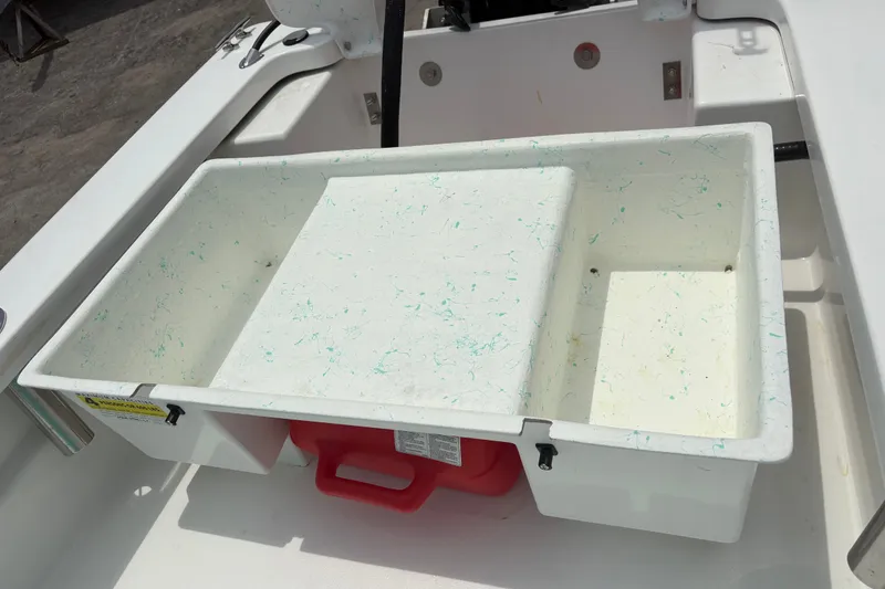 Slide: The Image of Exuma 14 Snookaholic 2025 boat interior with storage compartment and red fuel tank. - 26