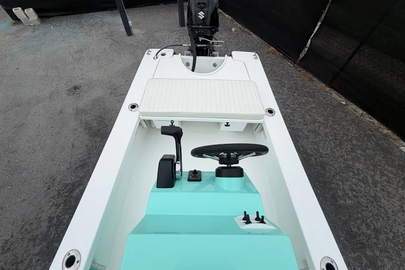 Slide: The Image of 2025 Exuma 14 Snookaholic boat interior with steering wheel and controls. - 43