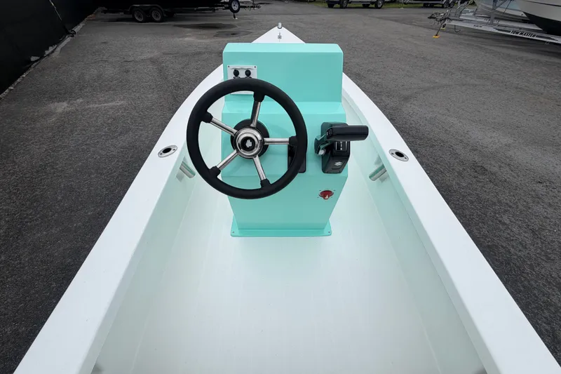 Slide: The Image of 2025 Exuma 14 Snookaholic boat interior with steering wheel and controls. - 15