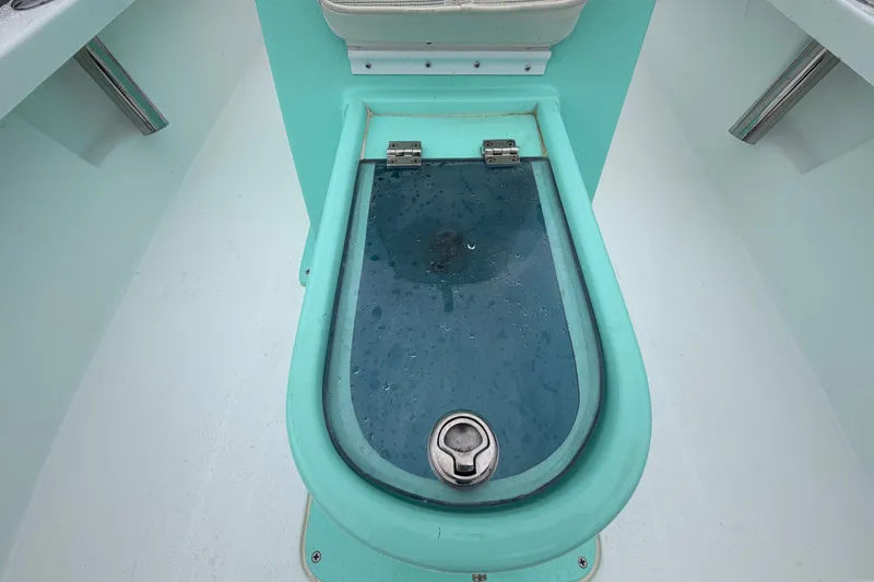 Slide: The Image of The image shows a turquoise boat with an oval, transparent lid in the center. - 35