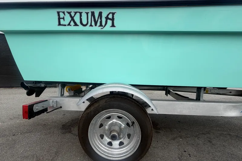 Slide: The Image of 2025 Exuma 14 Snookaholic boat on trailer, showcasing mint green hull and brand logo. - 58