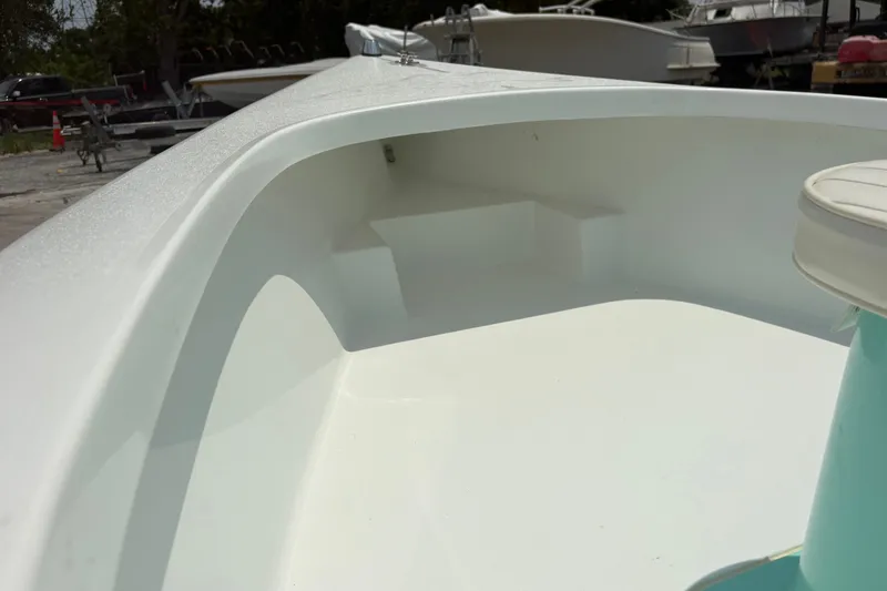 Slide: The Image of Interior view of a 2025 Exuma 14 Snookaholic boat, showcasing sleek white design. - 13