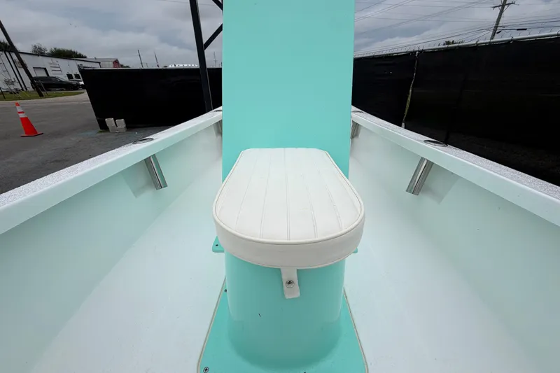 Slide: The Image of 2025 Exuma 14 Snookaholic boat interior with white seat and turquoise accents. - 33