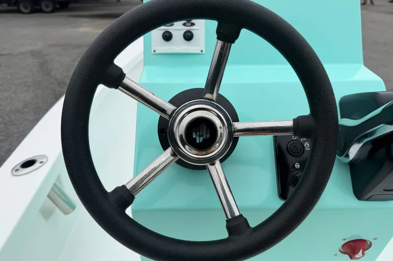 Slide: The Image of Steering wheel of 2025 Exuma 14 Snookaholic boat, featuring sleek design and controls. - 18