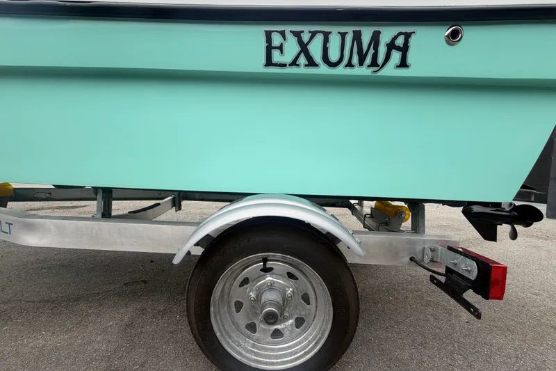 Slide: The Image of 2025 Exuma 14 Snookaholic boat on trailer, mint green hull, close-up view. - 57