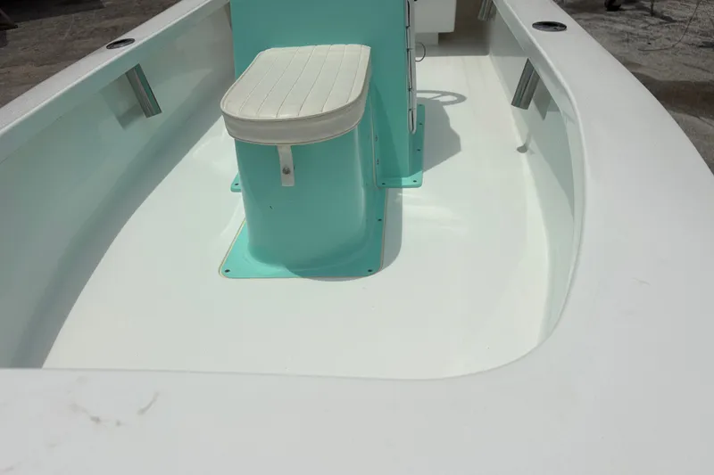 Slide: The Image of 2025 Exuma 14 Snookaholic boat interior with turquoise console and white seat. - 15