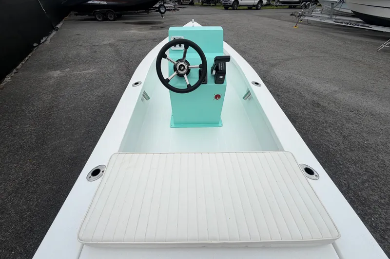 Slide: The Image of 2025 Exuma 14 Snookaholic boat with mint green console and white seating. - 13
