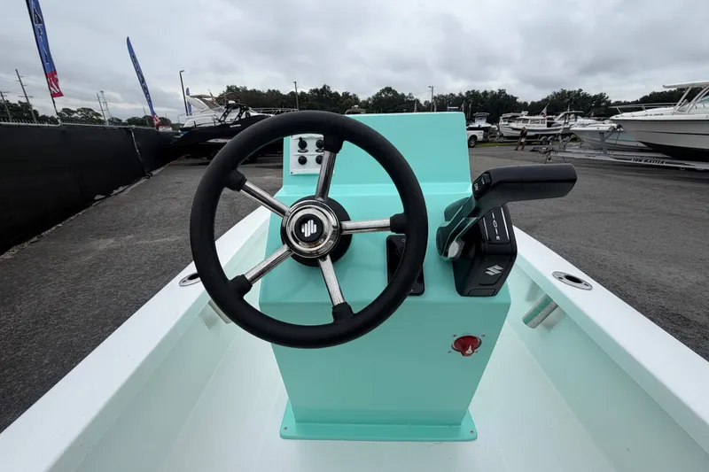 Slide: The Image of Steering console of 2025 Exuma 14 Snookaholic boat, featuring a sleek design and modern controls. - 16