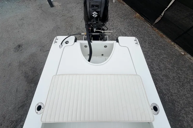 Slide: The Image of The image shows the stern of an Exuma 14 Snookaholic boat with an outboard motor. - 47