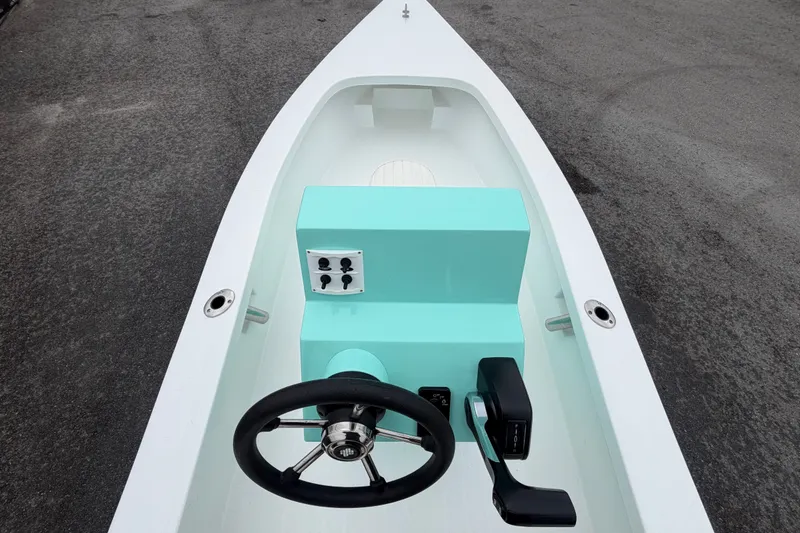 Slide: The Image of 2025 Exuma 14 Snookaholic boat interior with turquoise console and steering wheel. - 23