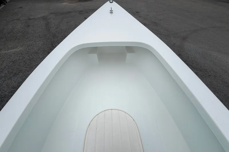 Slide: The Image of 2025 Exuma 14 Snookaholic boat interior, showcasing sleek white design and spacious layout. - 27