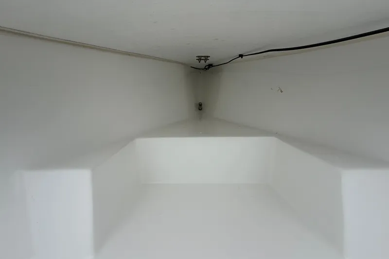 Slide: The Image of Interior view of 2025 Exuma 14 Snookaholic boat compartment, featuring clean white surfaces. - 29