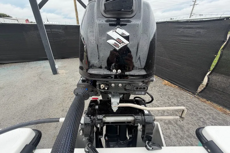 Slide: The Image of 2025 Exuma 14 Snookaholic boat with Suzuki outboard motor, parked outdoors. - 53