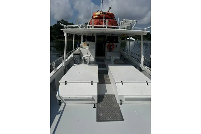 Slide: The Image of 1999 Markley 46 Chesapeake boat with COI, featuring spacious deck and safety equipment. - 7
