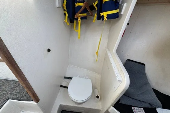 Slide: The Image of 1999 Markley 46 Chesapeake boat interior with toilet and life jackets. - 11