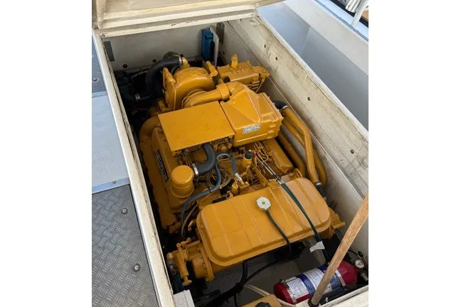 Slide: The Image of Yellow engine in a 1999 Markley 46 Chesapeake boat, with visible fire extinguisher. - 9