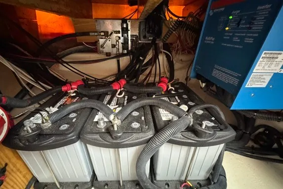 Slide: The Image of Battery compartment of a 1999 Markley 46 Chesapeake boat, featuring wiring and inverter. - 13