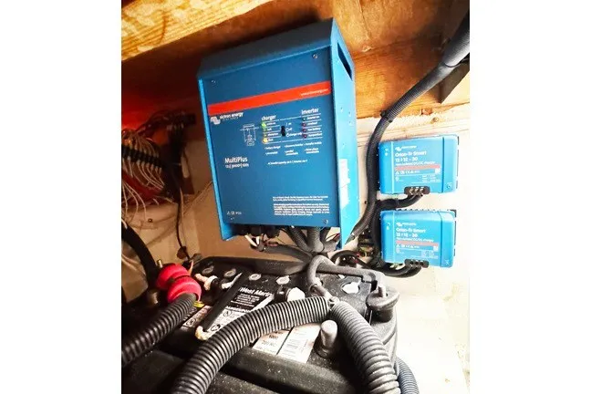 Slide: The Image of Electrical system setup in a 1999 Markley 46 Chesapeake boat, featuring a Victron MultiPlus inverter. - 12