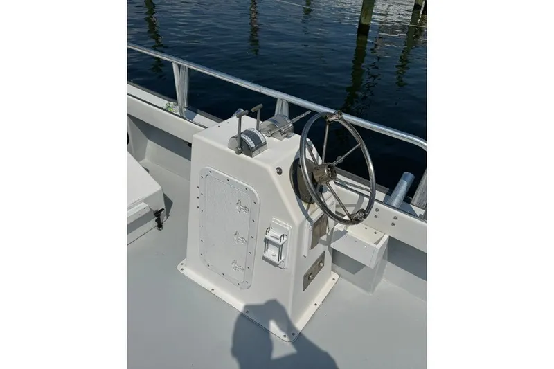Slide: The Image of Steering console of a 1999 Markley 46 Chesapeake boat, docked by the water. - 5