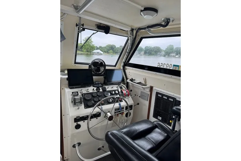 Slide: The Image of Interior of a 1999 Markley 46 Chesapeake boat cockpit with steering wheel and controls. - 4