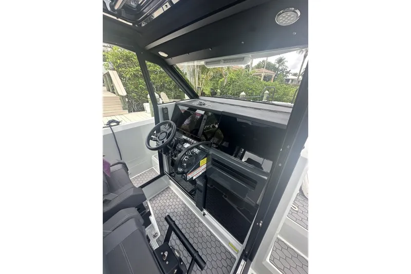 Slide: The Image of Interior view of 2023 XO DFNDR 9 boat cockpit with modern steering and controls. - 15