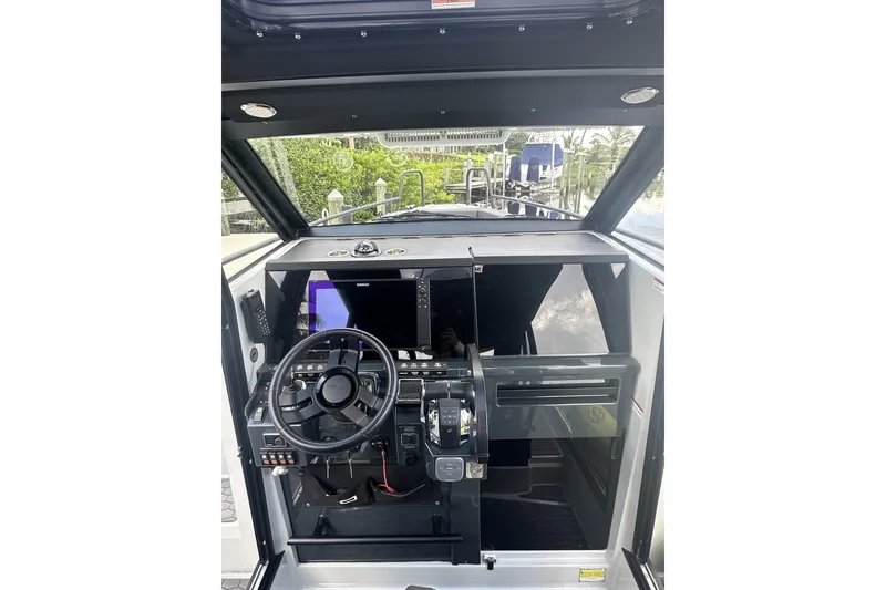 Slide: The Image of 2023 XO DFNDR 9 boat cockpit with steering wheel and control panel. - 13