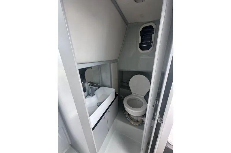 Slide: The Image of Modern bathroom interior of 2023 XO DFNDR 9 boat, featuring sink and toilet. - 20