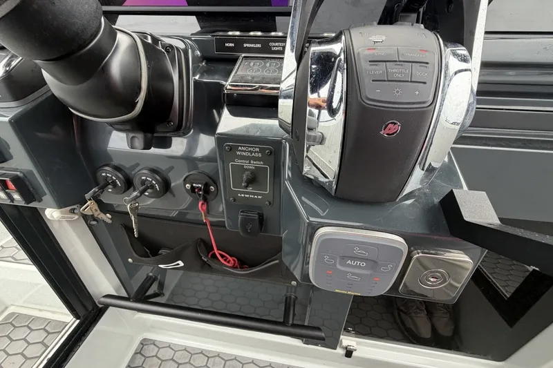 Slide: The Image of Control panel of 2023 XO DFNDR 9 boat with throttle and anchor windlass switches. - 7