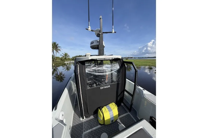 Slide: The Image of 2023 XO DFNDR 9 boat on calm water, featuring sleek design and modern equipment. - 10