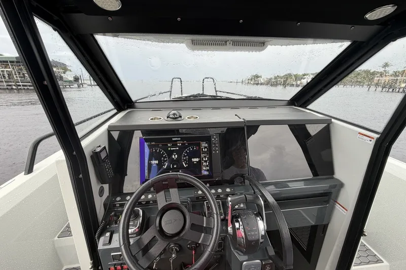 Slide: The Image of Cockpit view of 2023 XO DFNDR 9 boat with modern navigation controls. - 4
