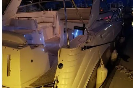Slide: The Image of 2006 Rinker Fiesta Vee 342 boat docked at night with illuminated interior. - 2