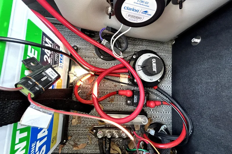 Slide: The Image of Electrical setup in a 2025 Godfrey Sweetwater 2286 SFL boat, featuring battery and wiring components. - 28