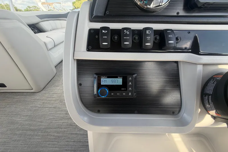 Slide: The Image of Control panel of 2025 Godfrey Sweetwater 2286 SFL boat with radio and switches. - 36