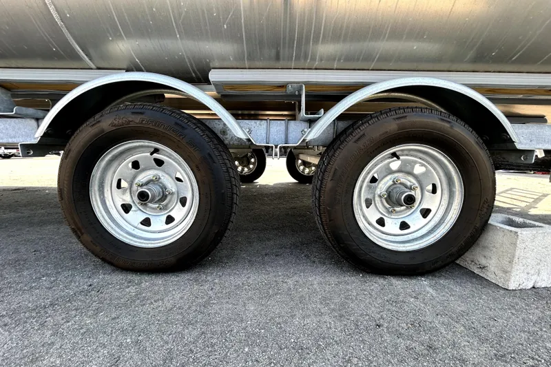 Slide: The Image of Trailer wheels of a 2025 Godfrey Sweetwater 2286 SFL pontoon boat on pavement. - 51