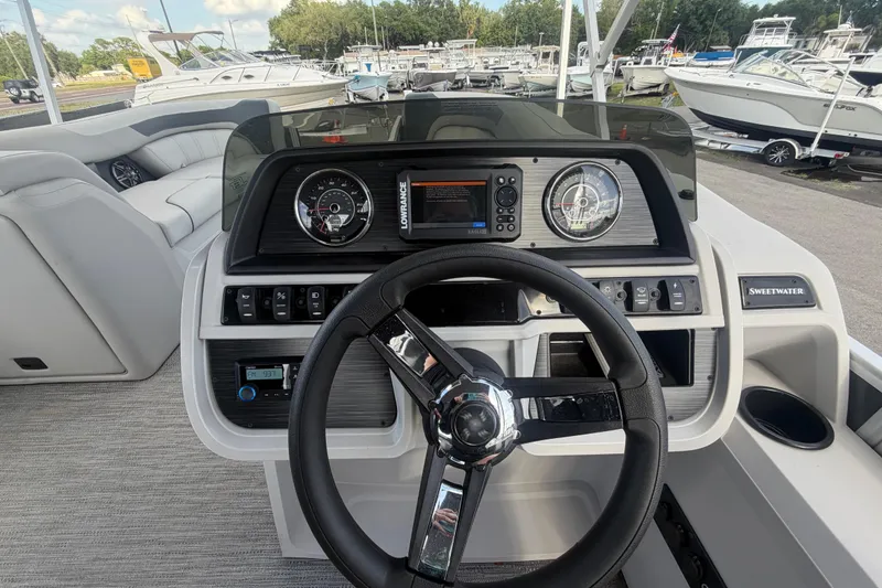 Slide: The Image of Helm of 2025 Godfrey Sweetwater 2286 SFL pontoon boat with modern controls and steering wheel. - 34
