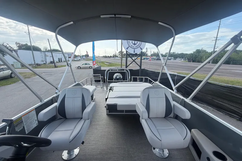 Slide: The Image of 2025 Godfrey Sweetwater 2286 SFL pontoon boat interior with seating and canopy. - 17