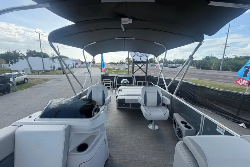 Slide: The Image of 2025 Godfrey Sweetwater 2286 SFL pontoon boat interior with seating and canopy. - 16