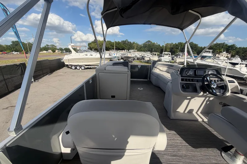Slide: The Image of 2025 Godfrey Sweetwater 2286 SFL pontoon boat interior with helm and seating. - 39