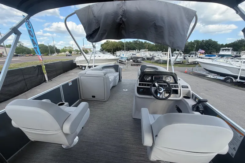 Slide: The Image of Interior view of 2025 Godfrey Sweetwater 2286 SFL pontoon boat at a marina. - 32