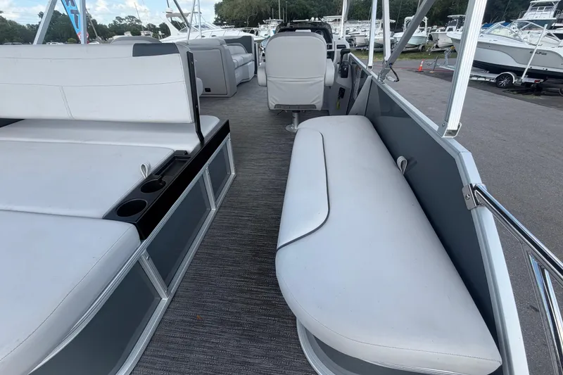 Slide: The Image of 2025 Godfrey Sweetwater 2286 SFL pontoon boat interior with white seating and cup holders. - 30