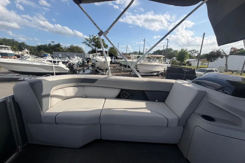 Slide: The Image of 2025 Godfrey Sweetwater 2286 SFL pontoon boat interior with plush seating and canopy. - 48