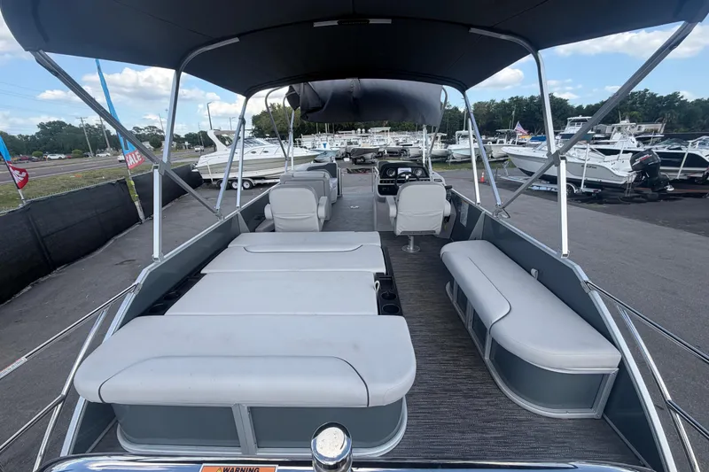 Slide: The Image of 2025 Godfrey Sweetwater 2286 SFL pontoon boat with spacious seating and canopy. - 23
