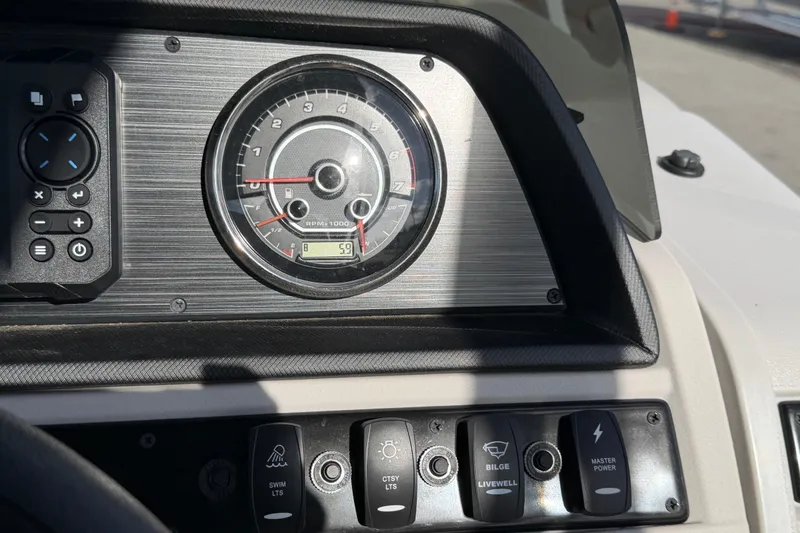 Slide: The Image of Dashboard of 2025 Godfrey Sweetwater 2286 SFL with tachometer and control buttons. - 37