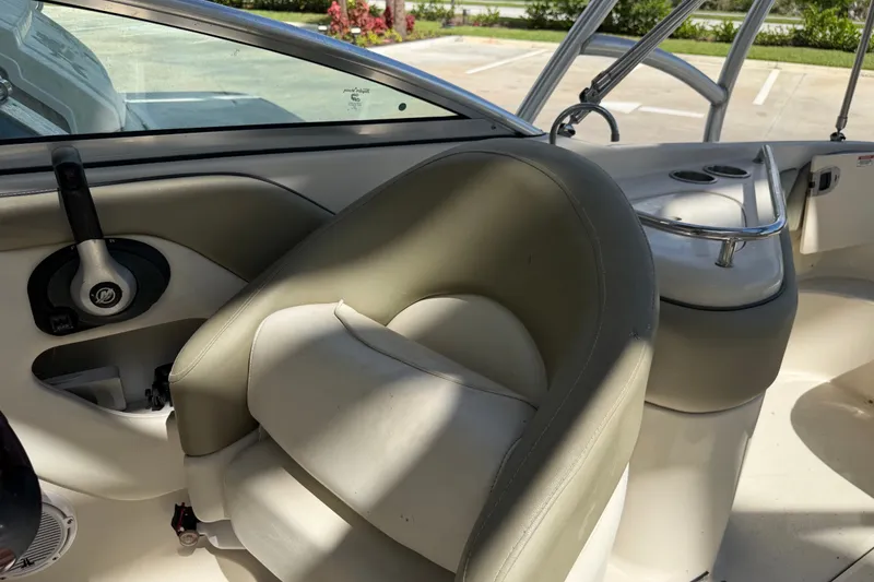 Slide: The Image of 2006 Sea Ray 240 Sundeck interior with steering wheel and seating area. - 19