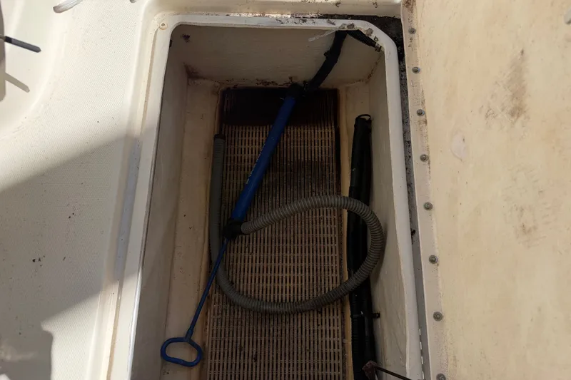 Slide: The Image of Storage compartment on a 2006 Sea Ray 240 Sundeck boat with equipment inside. - 17