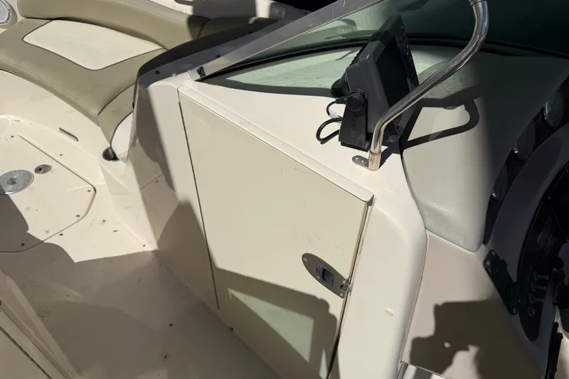 Slide: The Image of 2006 Sea Ray 240 Sundeck interior with seating and control panel. - 43