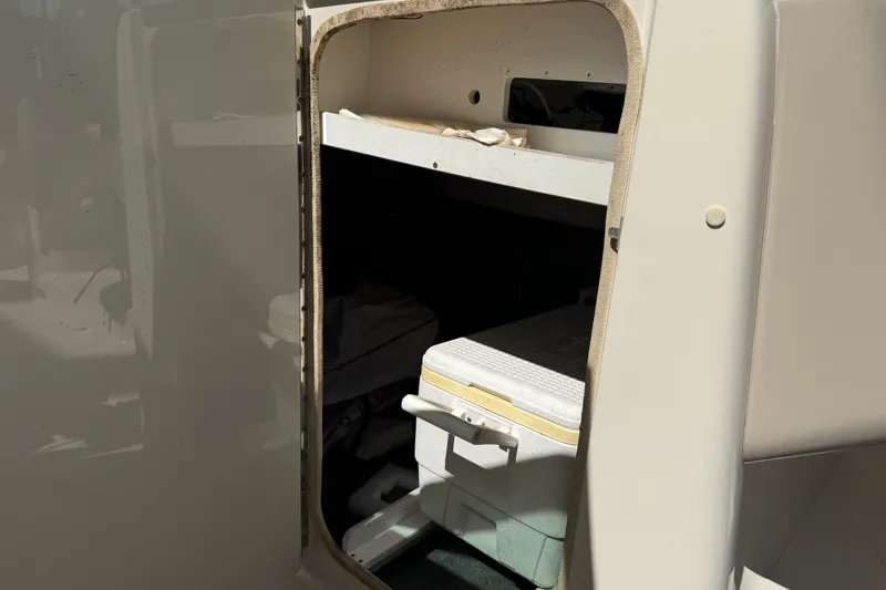 Slide: The Image of Storage compartment on a 2006 Sea Ray 240 Sundeck boat with cooler inside. - 44